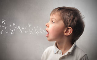 A boy with jumbled alphabet letters flowing from his open mouth