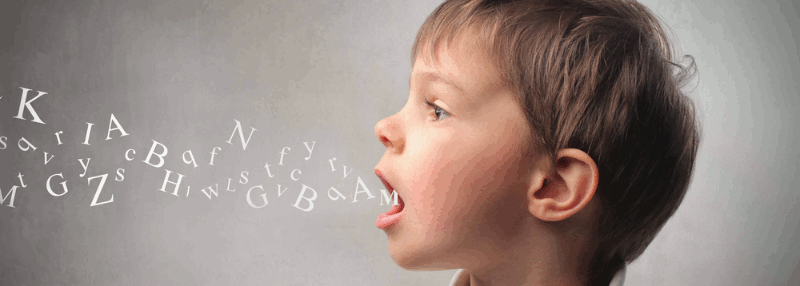 A boy with jumbled alphabet letters flowing from his open mouth